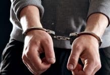 Offender with his hands in handcuffs