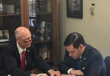 marco rubio and rick scott reviewing document 525x420