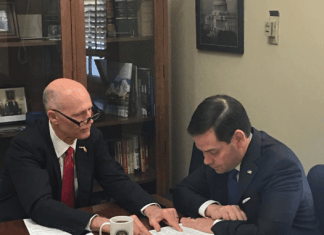 marco rubio and rick scott reviewing document 525x420