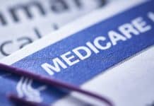 closeup of a Medicare health insurance card with a paperclip