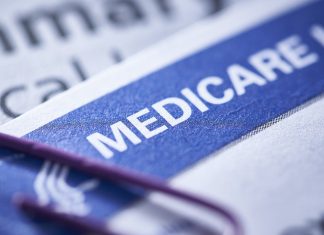 closeup of a Medicare health insurance card with a paperclip