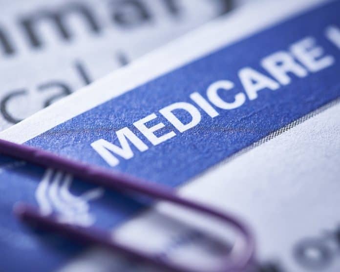 closeup of a Medicare health insurance card with a paperclip