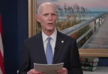 rick scott holding papers 800x420