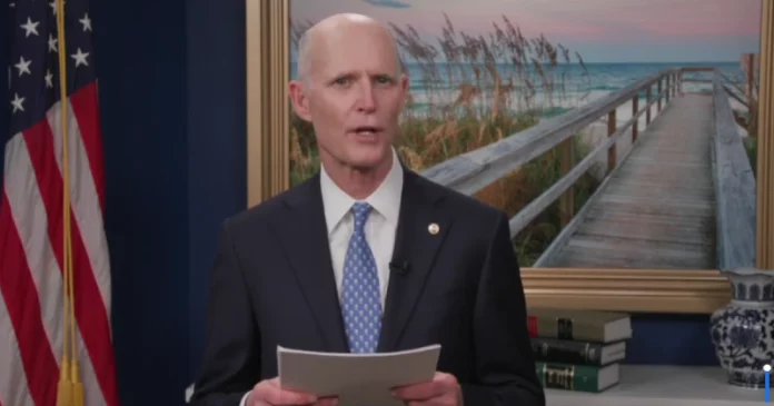 rick scott holding papers 800x420